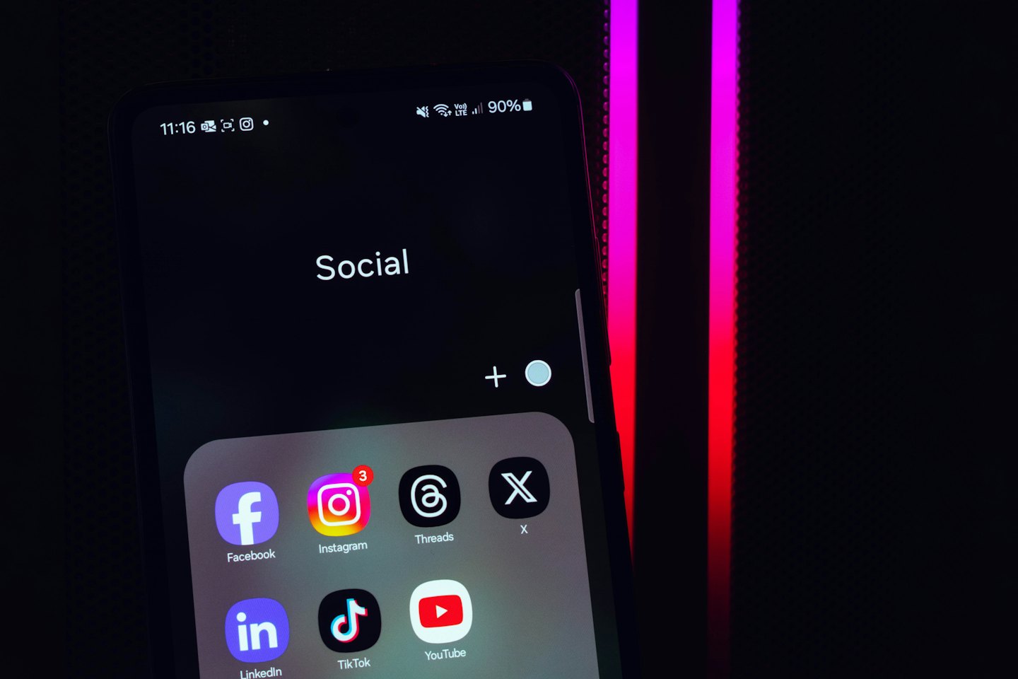 Smartphone screen showing social media app icons and folders.